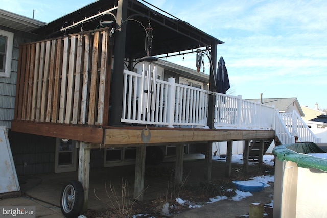 view of property exterior with a wooden deck