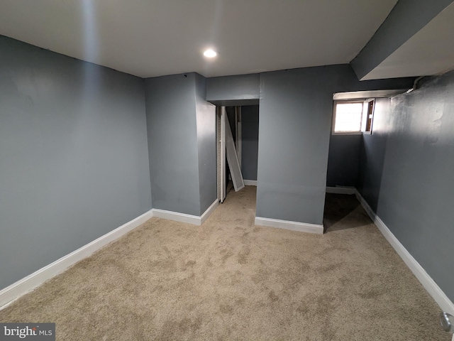 basement featuring light carpet