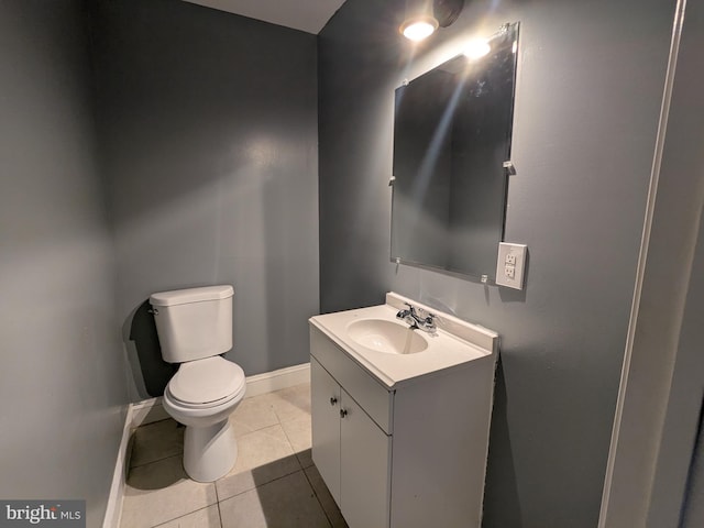 bathroom featuring tile patterned floors, toilet, and vanity