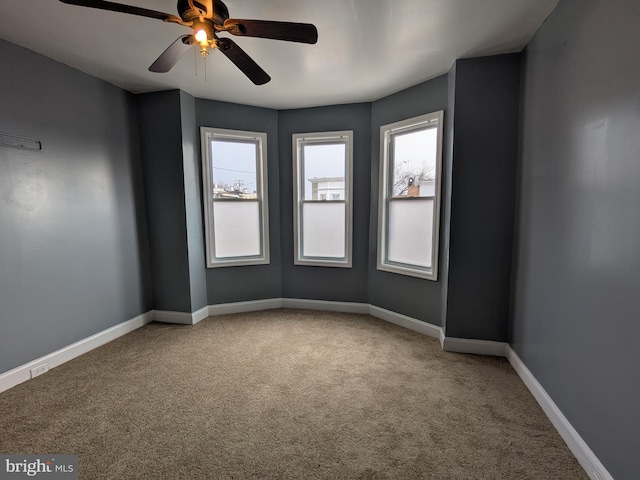 unfurnished room featuring carpet and ceiling fan