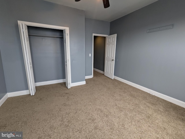 unfurnished bedroom with carpet floors, ceiling fan, and a closet