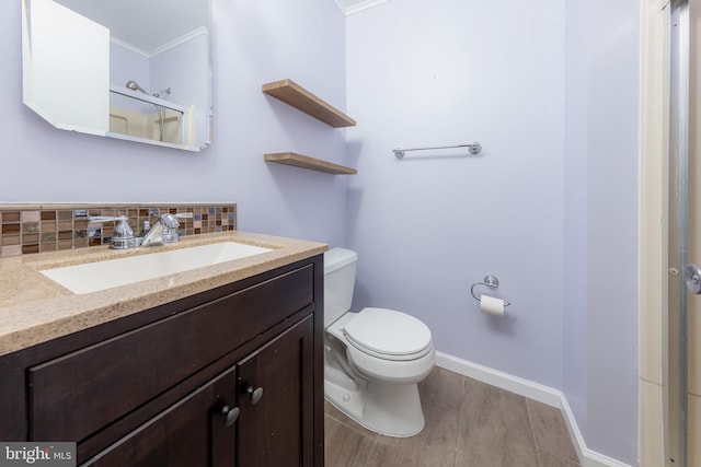 bathroom featuring backsplash, toilet, vanity, hardwood / wood-style flooring, and an enclosed shower