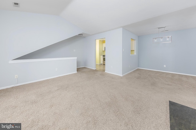 interior space with lofted ceiling and carpet