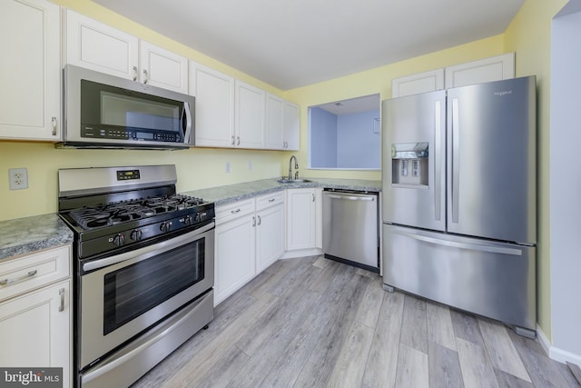 kitchen with appliances with stainless steel finishes and white cabinetry