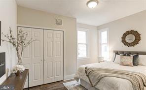 bedroom with a closet and dark hardwood / wood-style flooring