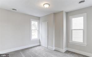 unfurnished bedroom featuring light colored carpet