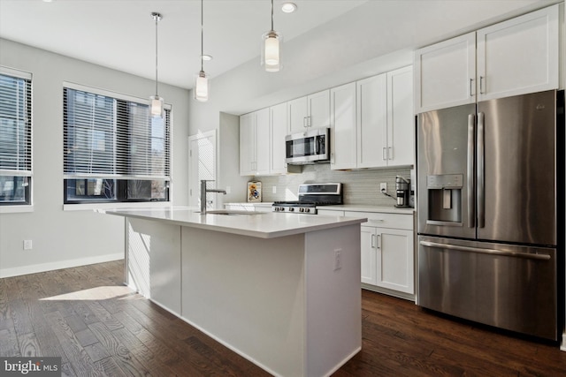 kitchen featuring stainless steel appliances, white cabinetry, a kitchen island with sink, and sink