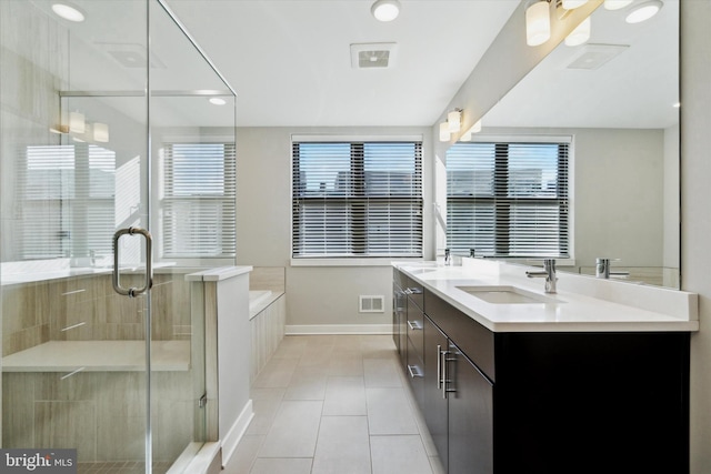 bathroom with tile patterned floors, vanity, and shower with separate bathtub