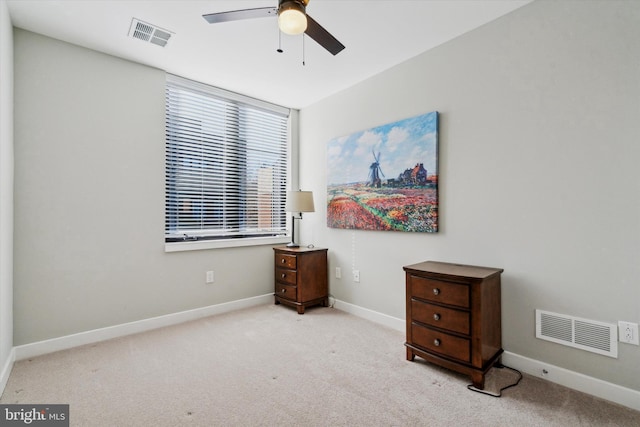 interior space featuring ceiling fan and light carpet