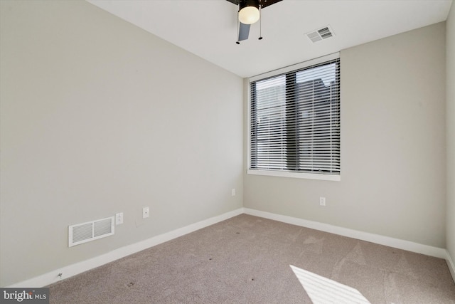 carpeted spare room with ceiling fan