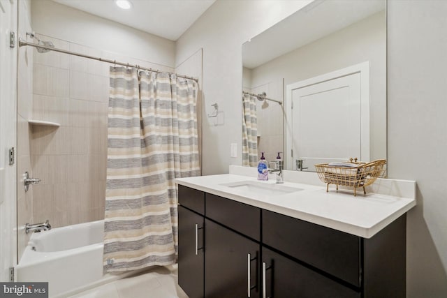 bathroom featuring tile patterned flooring, vanity, and shower / tub combo