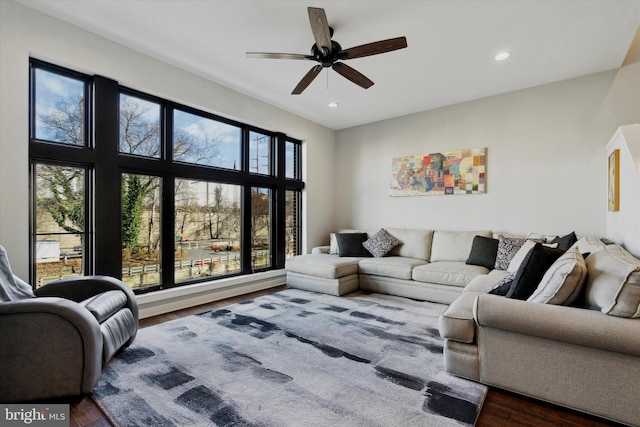 living room featuring hardwood / wood-style flooring, plenty of natural light, and ceiling fan