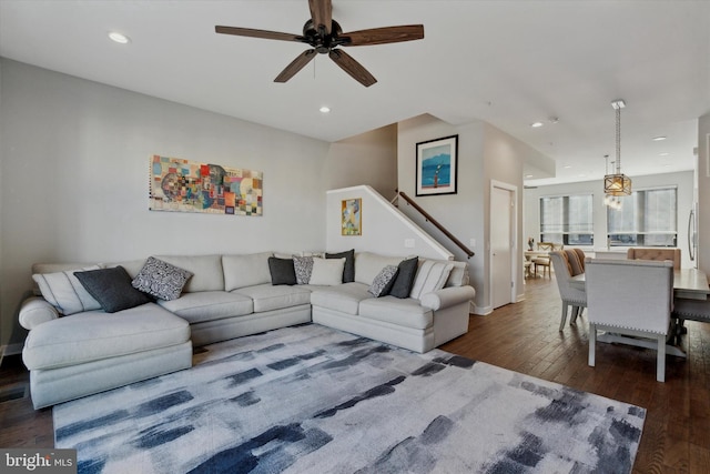 living room with dark hardwood / wood-style flooring and ceiling fan