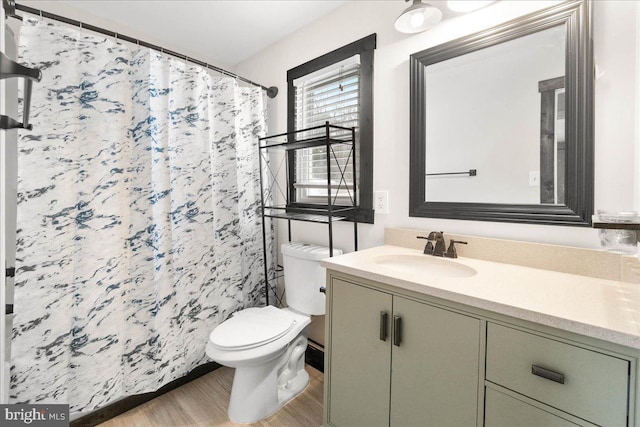 bathroom with hardwood / wood-style floors, vanity, toilet, and a shower with shower curtain