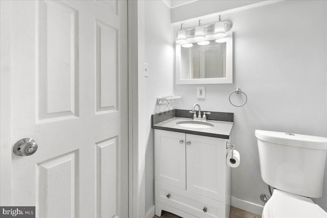 bathroom featuring vanity and toilet