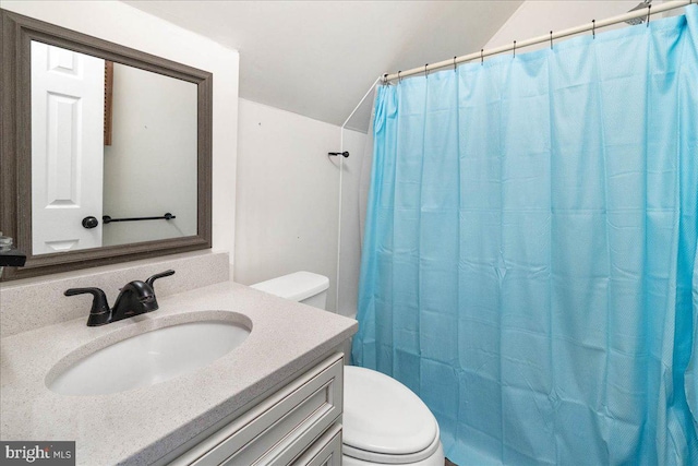 bathroom with a shower with shower curtain, vanity, toilet, and lofted ceiling