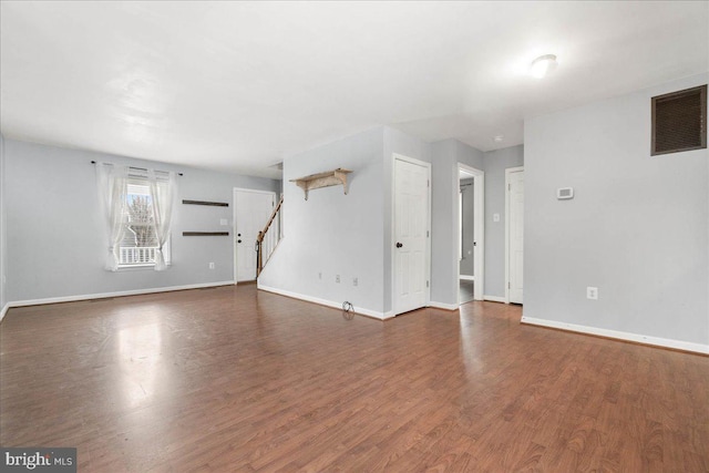 spare room featuring dark wood-type flooring