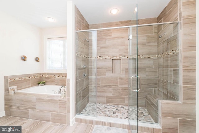 bathroom featuring tile patterned flooring and independent shower and bath