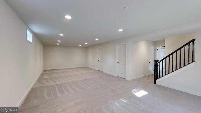 basement featuring light colored carpet