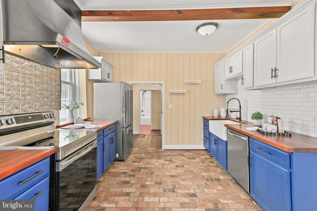 kitchen featuring wood counters, appliances with stainless steel finishes, extractor fan, sink, and white cabinetry