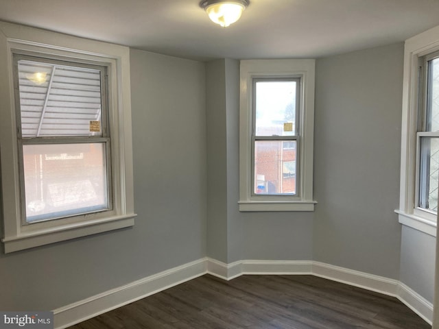 spare room with dark hardwood / wood-style floors