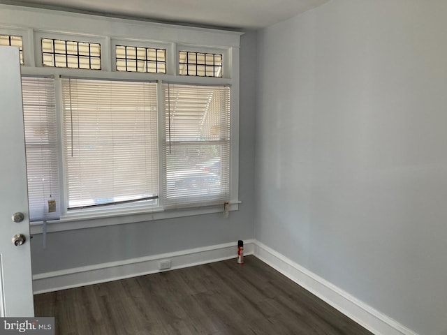 spare room with dark hardwood / wood-style flooring