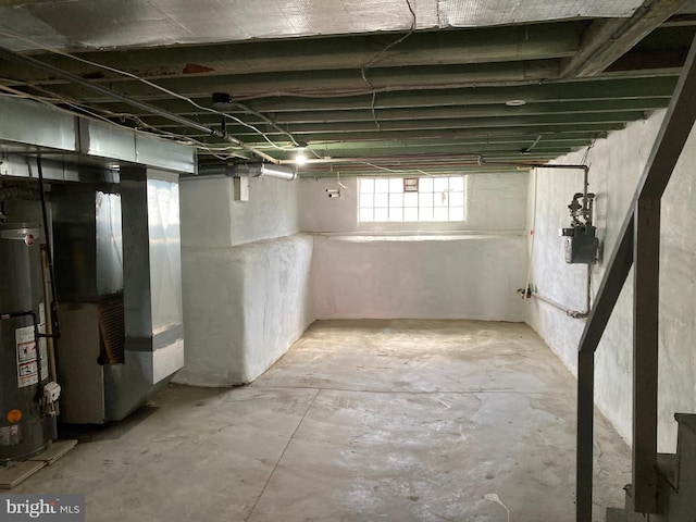 basement featuring heating unit and water heater