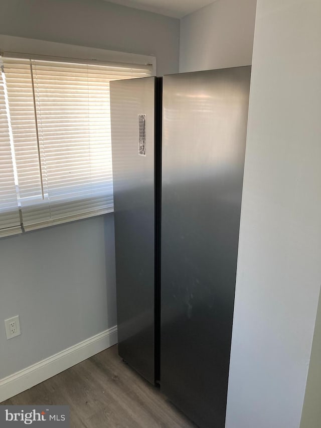 interior details featuring stainless steel refrigerator and wood-type flooring