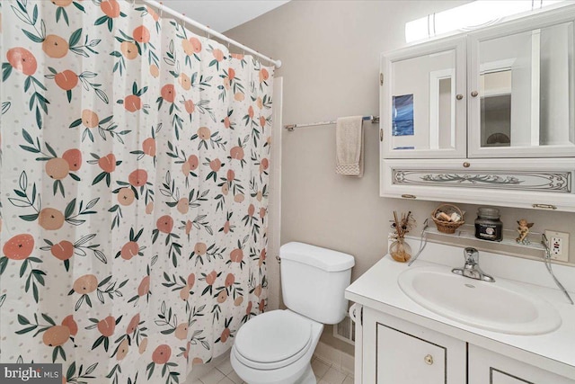 bathroom with toilet, vanity, a shower with curtain, and tile patterned flooring