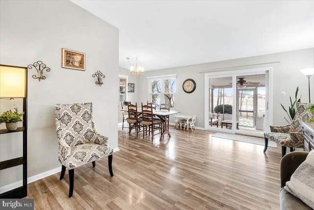 interior space with lofted ceiling, an inviting chandelier, and light hardwood / wood-style floors