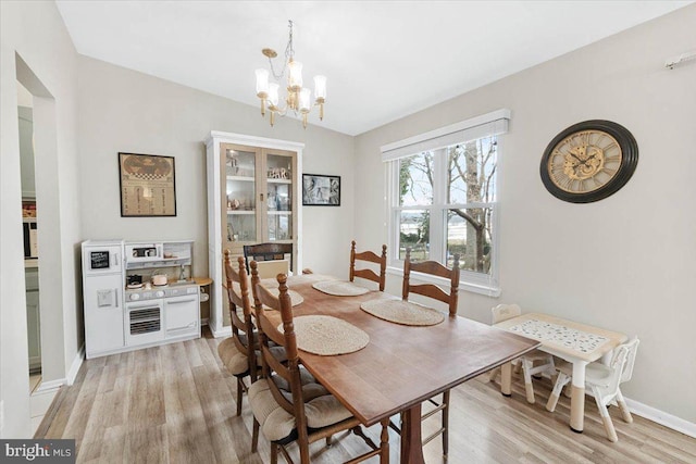 dining room featuring an inviting chandelier and light hardwood / wood-style floors