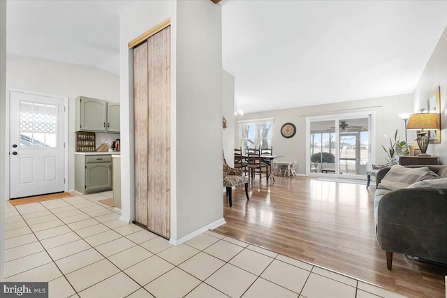 interior space featuring light tile patterned floors and vaulted ceiling