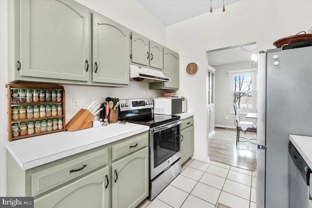 kitchen with light tile patterned floors, appliances with stainless steel finishes, and green cabinetry