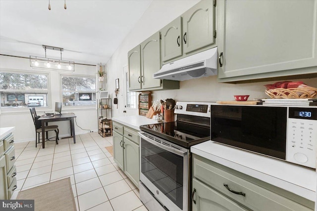 kitchen featuring green cabinetry, light tile patterned floors, and electric stove