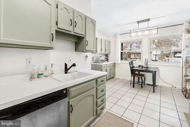 kitchen with pendant lighting, dishwasher, sink, green cabinetry, and light tile patterned flooring