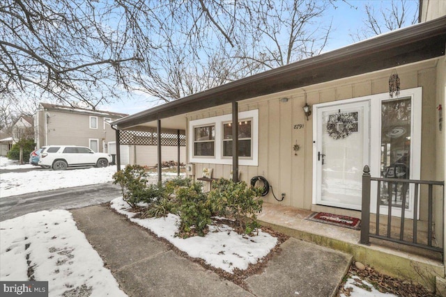 view of snow covered property entrance