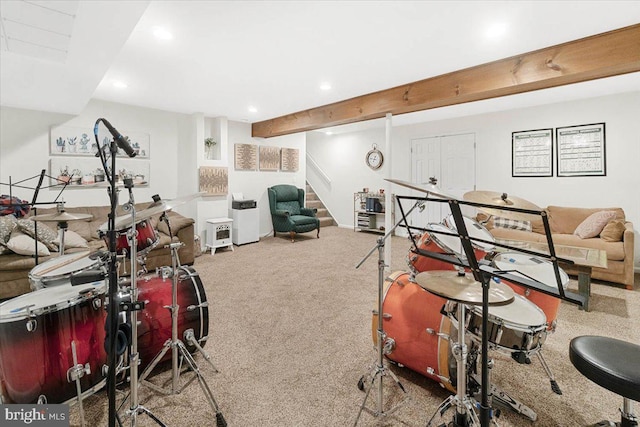 recreation room with beamed ceiling and carpet flooring