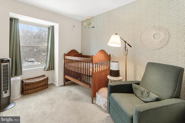 bedroom with a nursery area, light carpet, and a notable chandelier