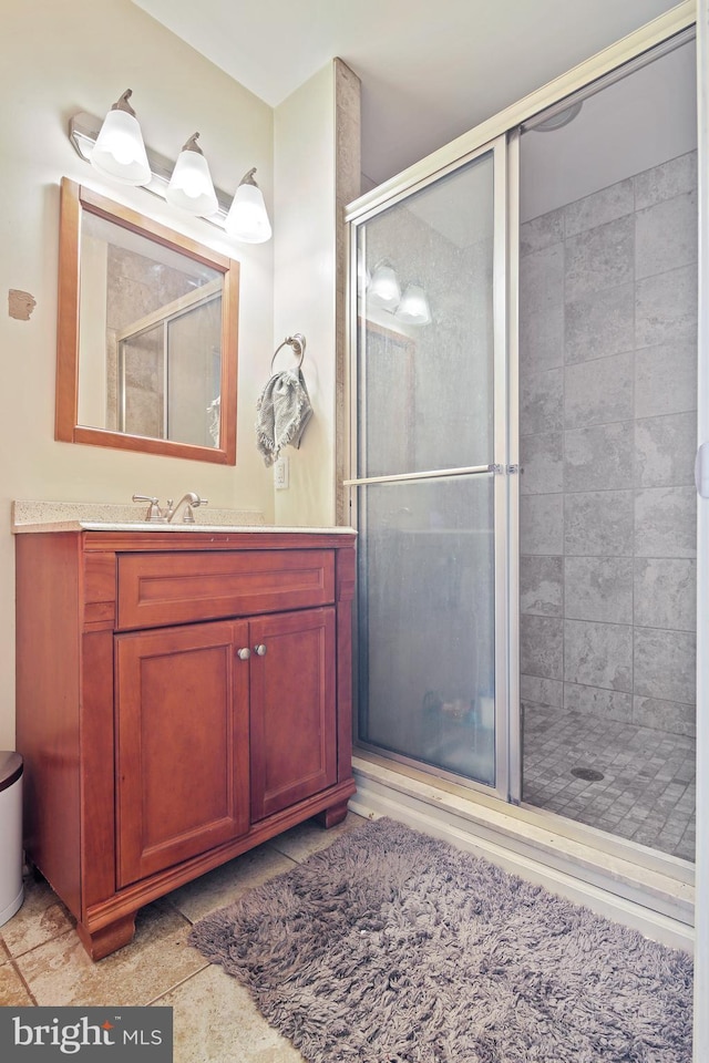 bathroom featuring vanity and a shower stall