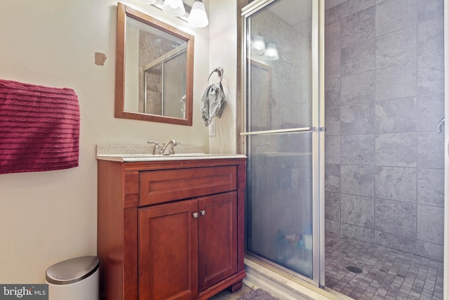 full bathroom with vanity and a shower stall