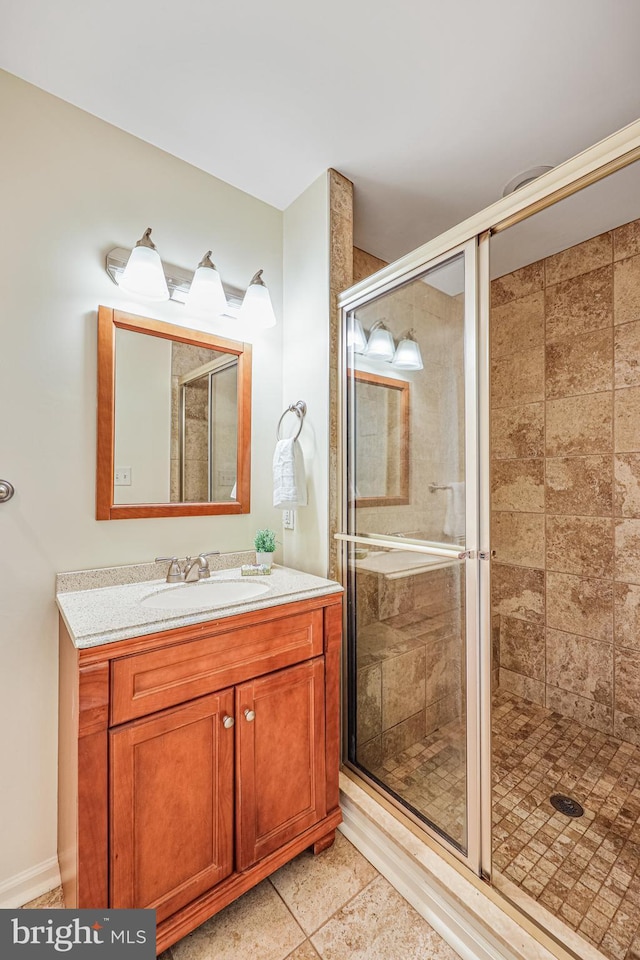 bathroom featuring vanity and a shower stall