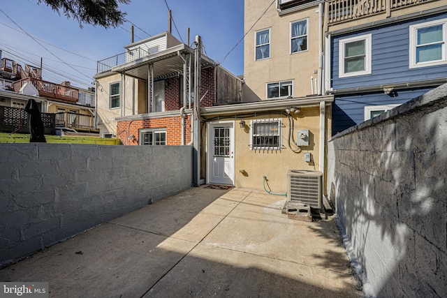 rear view of property with a patio, fence, central AC, and stucco siding