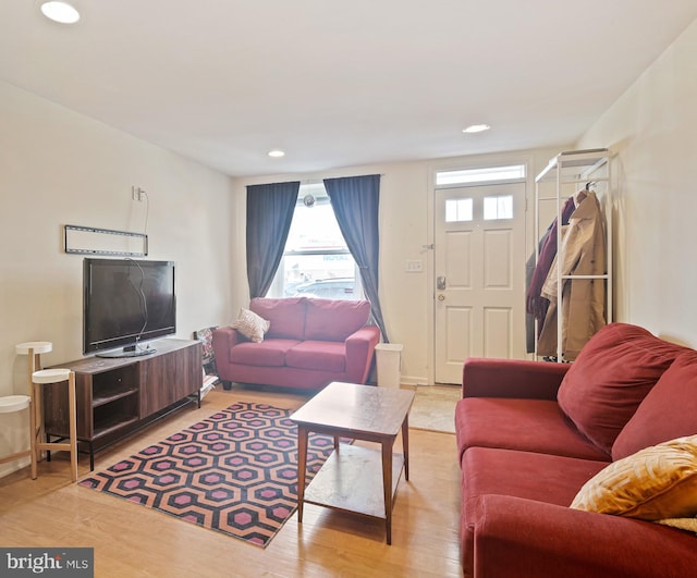 living room with recessed lighting, light wood-style flooring, and baseboards