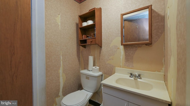 bathroom featuring toilet and vanity