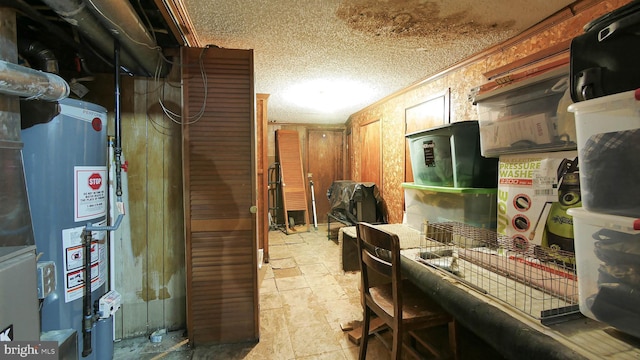 kitchen with ornamental molding and gas water heater