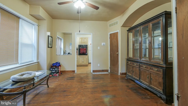 dining area featuring ceiling fan and dark wood-type flooring