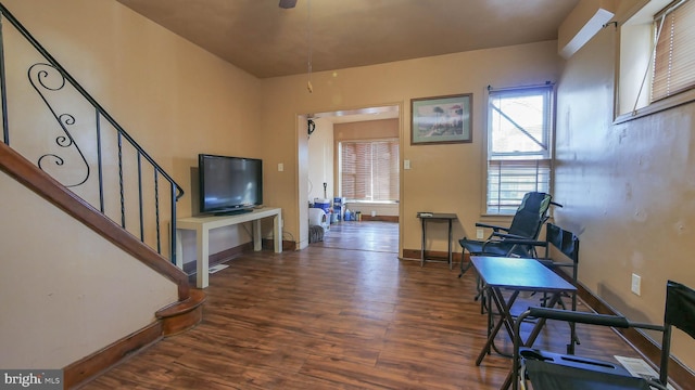 sitting room with dark wood-type flooring