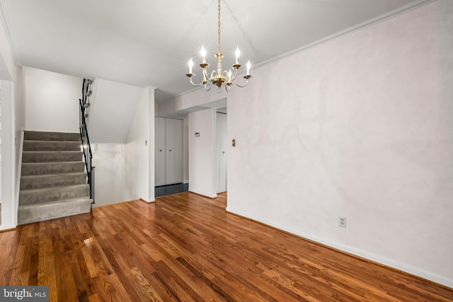 interior space featuring a notable chandelier, wood-type flooring, and crown molding