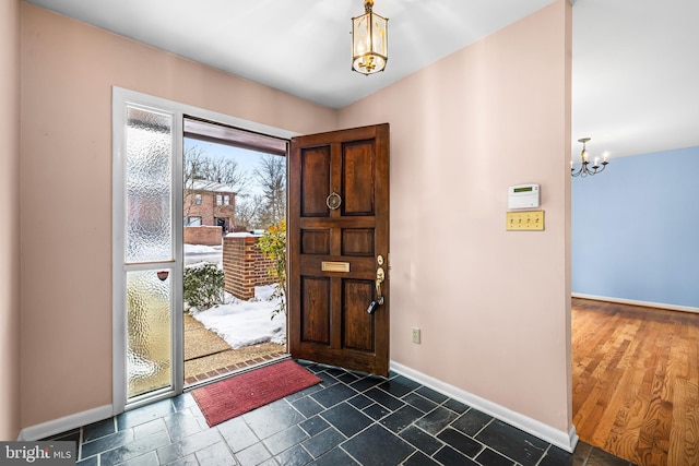 foyer entrance featuring an inviting chandelier