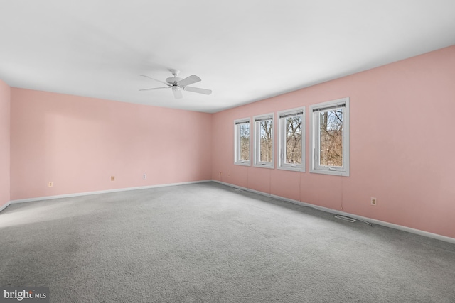 spare room with ceiling fan and carpet floors